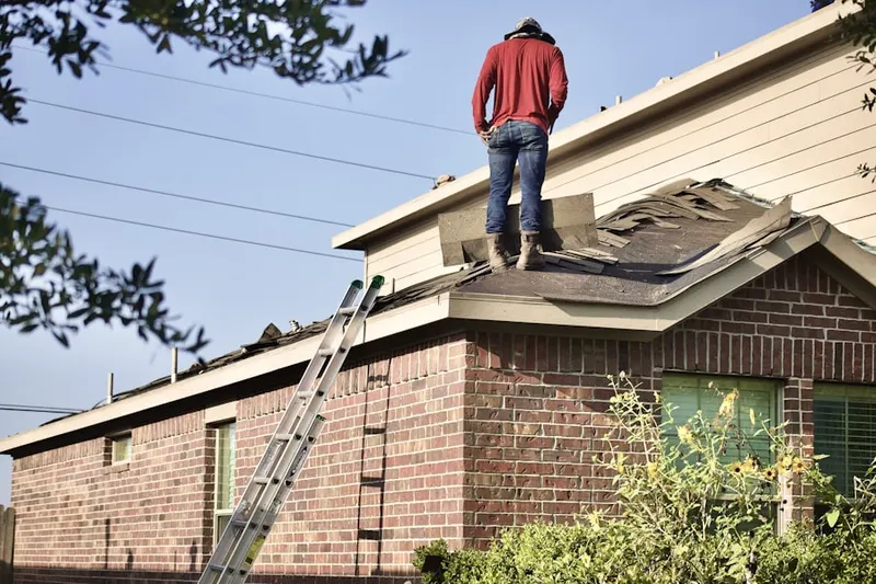 Professional roofer working on a residential roof in Country Club Heights